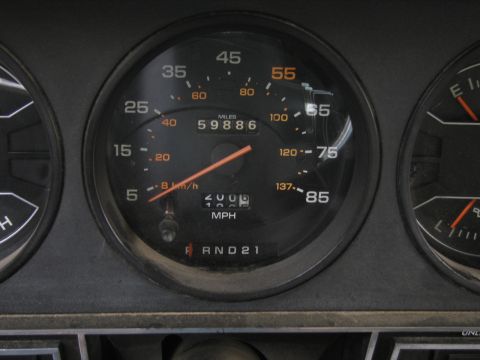 1987 Dodge 1500 - Interior view of a vehicle's dashboard gauges, displaying mileage and gear selection.