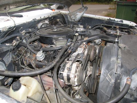 1987 Dodge 1500 - Close-up view of a vehicle's engine bay, showing various components.