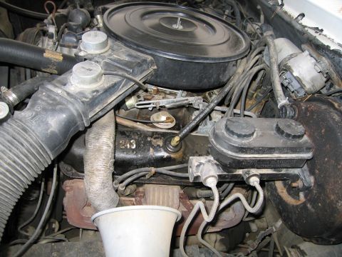 1987 Dodge 1500 - Close-up view of an engine bay, showing various components and wiring.