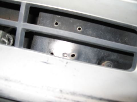 1987 Dodge 1500 - Close-up of the front grille of a 1987 Dodge 1500, revealing its construction and mounting points.