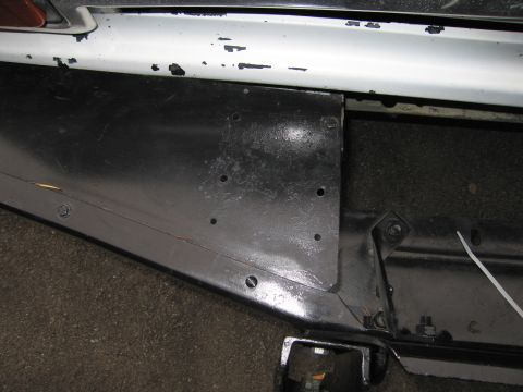 1987 Dodge 1500 - Detail of a vehicle's undercarriage, focusing on a bumper mounting bracket and frame components.