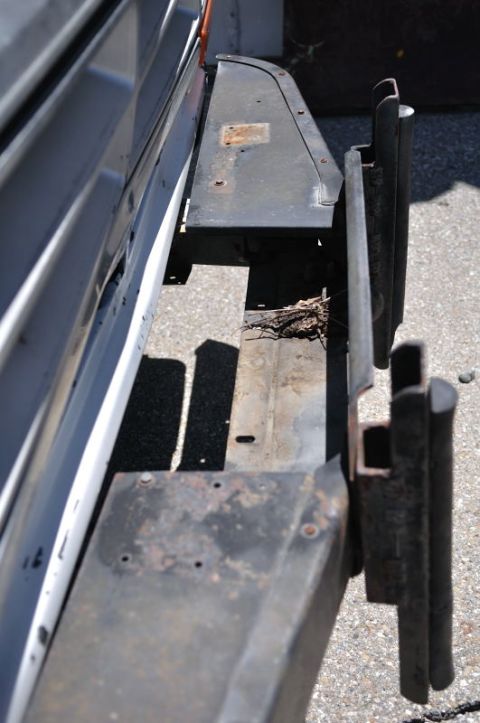 1987 Dodge 1500 - Close-up view of a worn truck bumper and frame components, showing signs of rust and damage.
