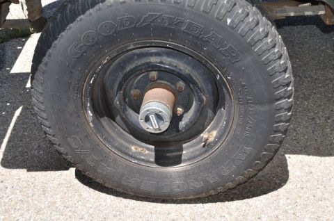 1987 Dodge 1500 - Close-up of a tire and wheel assembly, a Goodyear Wrangler AT/S tire and a Warn locking hub.