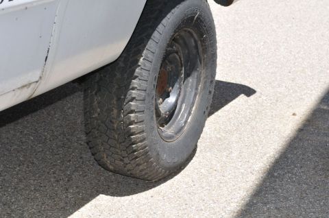 1987 Dodge 1500 - A close-up view of a vehicle's side, focusing on the tire and lower body panel.