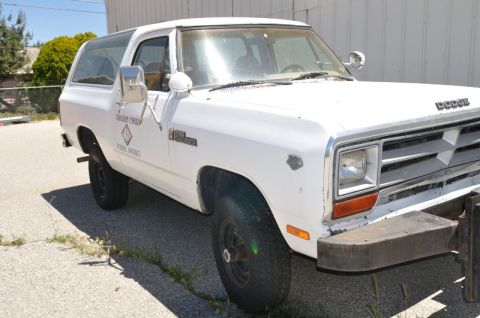 1987 Dodge 1500 - White 1987 Dodge Ramcharger SUV, a "FOREST SERVICE" decal on the door and a prominent Dodge grille.