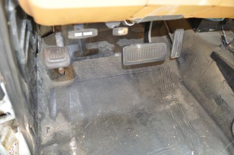 1987 Dodge 1500 - Interior view of the footwell and pedals in a 1987 Dodge 1500 pickup truck.