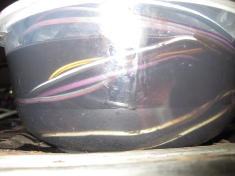 1979 Ford Bronco - A close-up view of a bundle of electrical wires, primarily purple, white, and yellow, contained within a dark plastic housing.