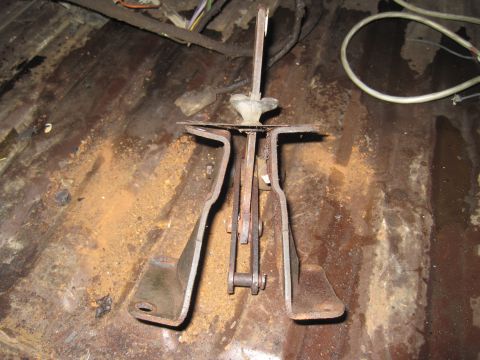 1979 Ford Bronco - Close-up of a rusty brake pedal assembly, likely from an older vehicle's interior floor.