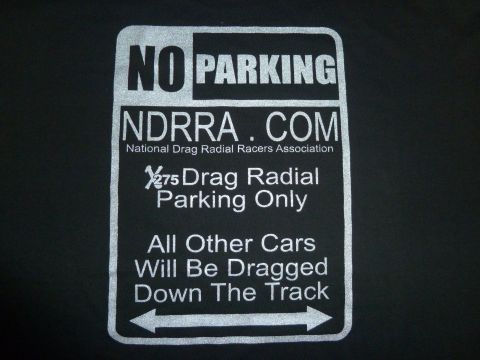 1992 Ford Mustang - A sign indicates parking restrictions for drag radial vehicles and warns other cars.