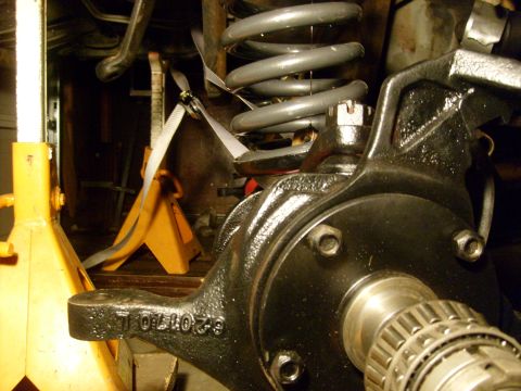 1986 Ford Bronco - A vehicle's suspension system is shown, with a focus on the knuckle and coil spring assembly.