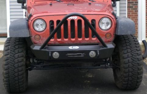 1996 Ford Bronco - Front view of a red Jeep Wrangler with an aftermarket bumper and winch.