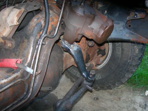1984 Ford Bronco - Undercarriage view of rusty steering and suspension components, likely from a truck or SUV.