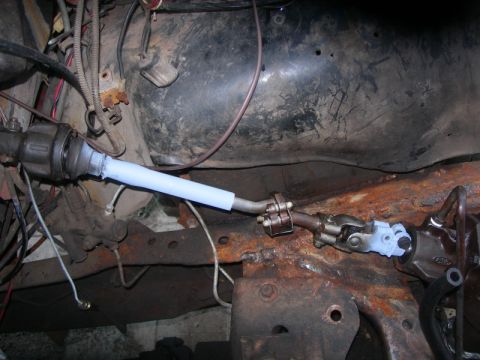 1984 Ford Bronco - Steering column linkage assembly, showing universal joints and protective wrapping.