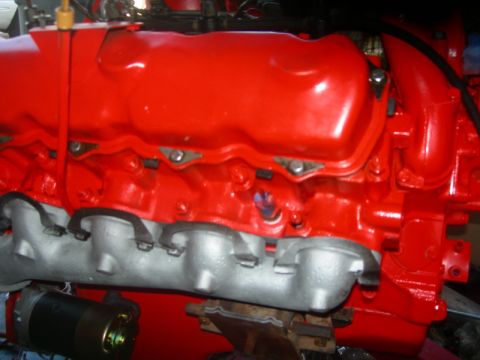 1984 Ford Bronco - Engine components, including the exhaust manifold and valve cover, are painted bright red.