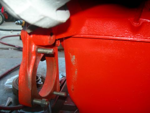 1984 Ford Bronco - Close-up of an engine block and its mounting bracket, with visible bolts and nuts.