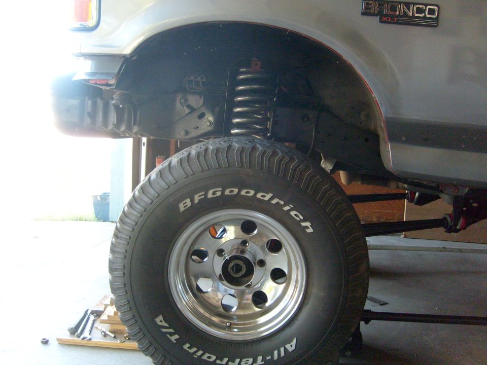 1986 Ford Bronco XLT side view showing front wheel, tire, and suspension components