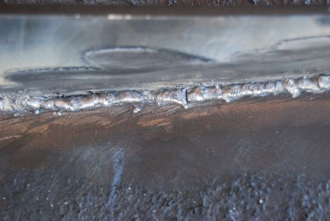 1982 Ford Bronco - This image shows a close-up view of a metal seam that has been welded, with visible texture and imperfections.