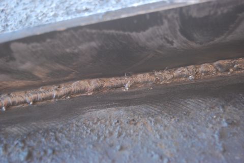 1982 Ford Bronco - A close-up view of a welded metal seam, showing the texture and condition of the material.