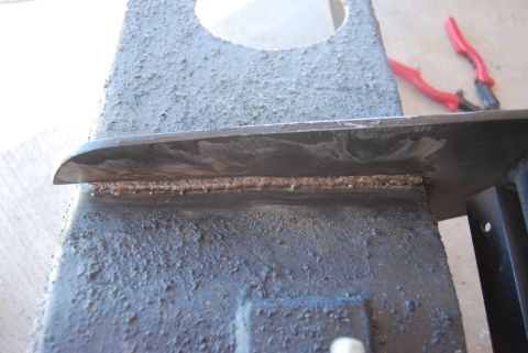 1982 Ford Bronco - Close-up of a welded metal component, with red pliers visible in the background.