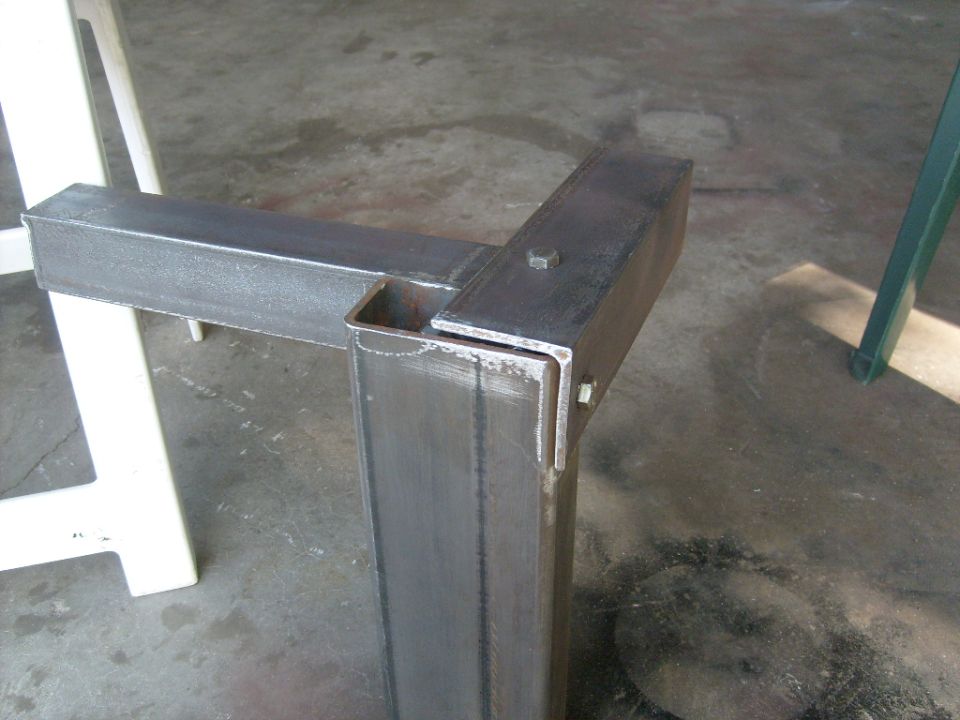 Close-up of a welded steel frame corner with a bolt and nut