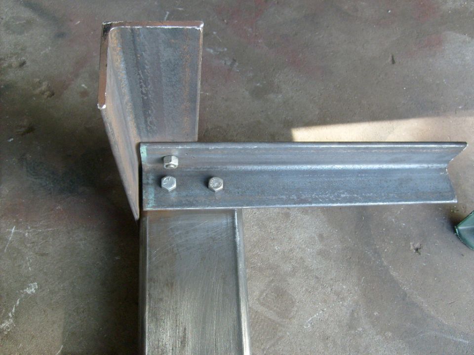 Metal brackets bolted together on a workshop floor
