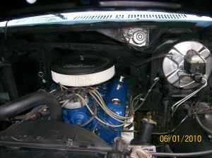 1981 Ford Bronco - Close-up view of the engine compartment, a blue engine block and visible SuperMotors branding.