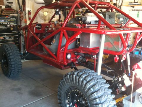 Suzuki Samurai - This custom buggy features a full roll cage and oversized tires, modified for off-road use.