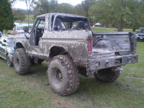 1979 Ford Bronco - This heavily modified 1979 Ford Bronco is covered in mud, a roll cage and oversized tires for off-road use.