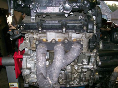 1995 Ford Probe - Close-up of an engine's exhaust manifold and associated components.
