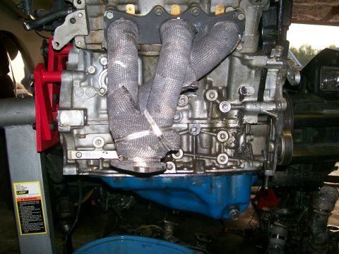 1995 Ford Probe - Close-up view of an engine block and exhaust manifold, suggesting a repair or modification process.