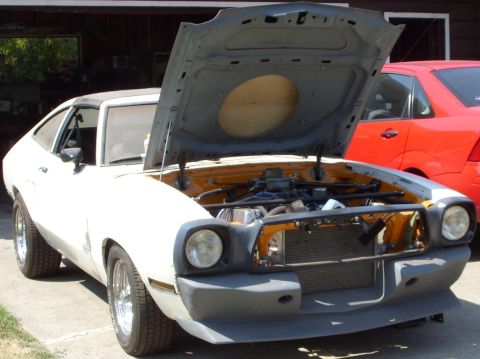 1978 Ford Mustang II - This 1978 Ford Mustang II is shown with its hood open, revealing the engine bay and a missing front grille.