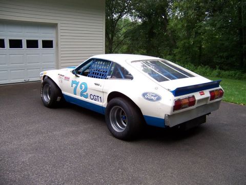 1978 Ford Mustang II - A modified 1978 Ford Mustang II race car is seen from a three-quarter rear view, parked on asphalt.