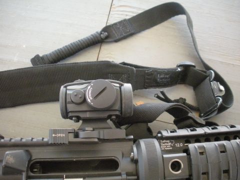 1996 Ford Bronco - Close-up of a tactical rifle scope and sling, with visible branding and operational text.