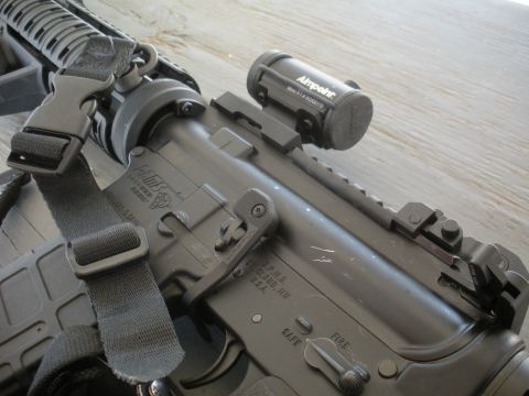 1996 Ford Bronco - Close-up view of an assault rifle with an Aimpoint sight.