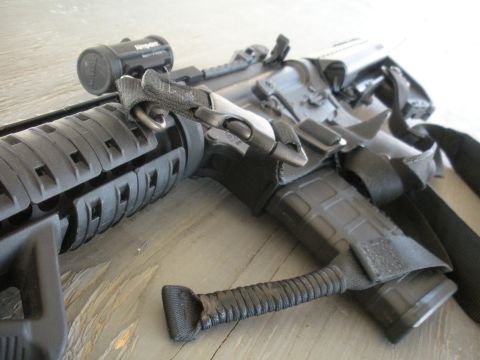1996 Ford Bronco - Close-up of a rifle's tactical foregrip, sling attachment, and mounted light, with a Supermotors.net watermark visible.
