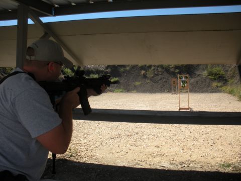 1996 Ford Bronco - Man at shooting range aiming rifle at targets downrange.