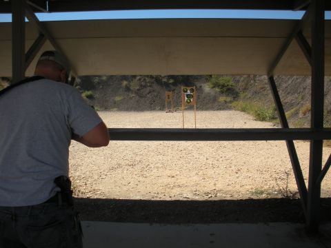 1996 Ford Bronco - A person aims a rifle at targets on a sunny day at the shooting range.