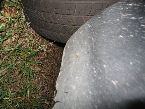 1991 Ford LTD Crown Victoria - Close-up view of two tires, one showing a detailed tread pattern, on the ground.