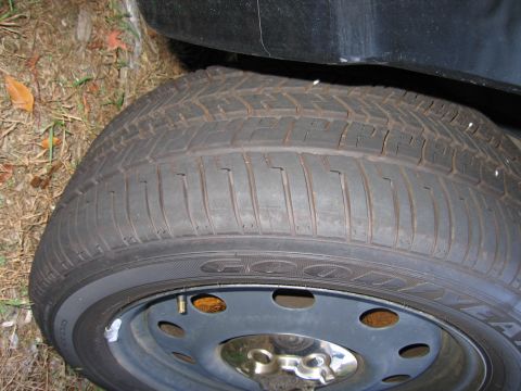 1991 Ford LTD Crown Victoria - A close-up view of a tire on a vehicle, showing the tread pattern and sidewall details.