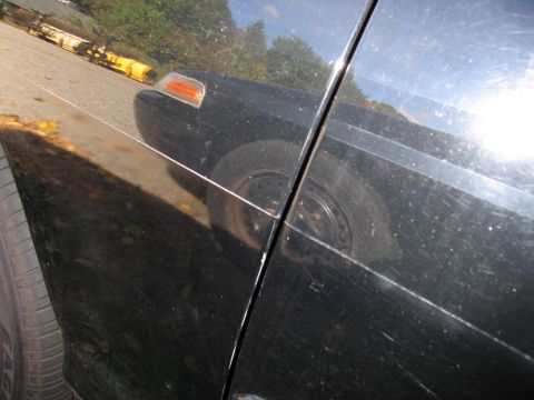 1991 Ford LTD Crown Victoria - Reflection of a black car's front fender and headlight is visible on the side panel.