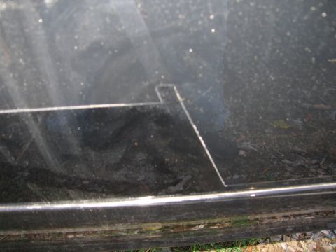 1991 Ford LTD Crown Victoria - Close-up of a dark car panel showing a cut-out and a horizontal trim line.