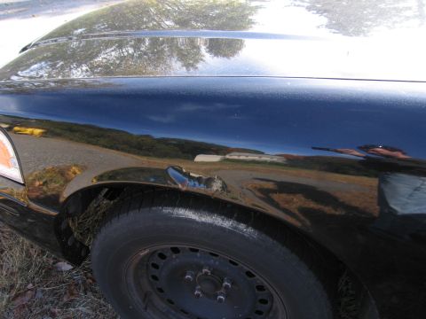 1991 Ford LTD Crown Victoria - Damage to the front fender of a 1991 Ford Crown Victoria LTD.