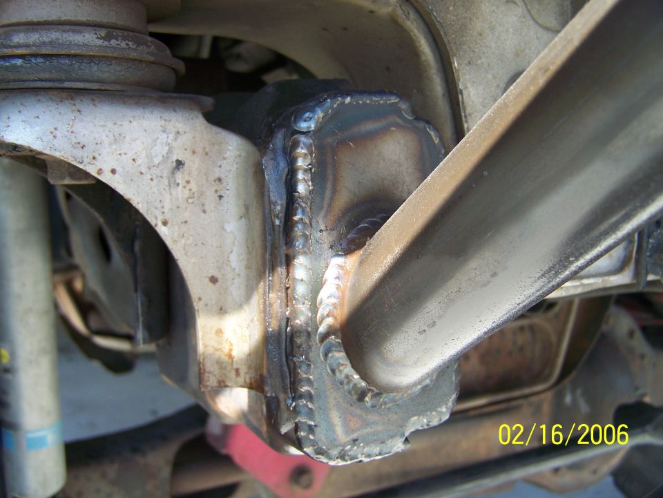 Welded suspension part on a vehicle, showing rough welds and metal fatigue