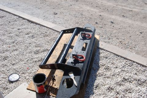 1982 Ford Bronco - Aftermarket front bumper with tow hooks and brush guard is ready for installation.