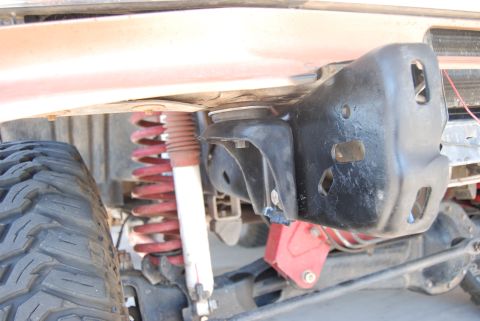 1982 Ford Bronco - This image shows the undercarriage of a vehicle, focusing on suspension parts and a tire.