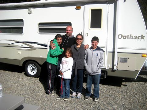 1996 Ford Bronco - Family poses for a photo in front of their Outback travel trailer.