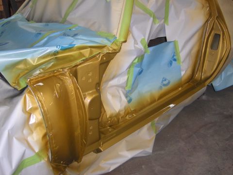 1970 Chevrolet Camaro - Gold paint being applied to a car's door jamb during a refinishing process.