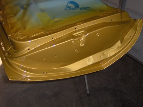 1970 Chevrolet Camaro - The inside of a gold-colored car door is shown, covered with protective plastic sheeting.