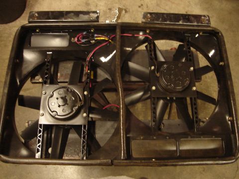 1989 Ford Bronco - Close-up of two black electric fans with visible wiring, mounted in a dark frame.