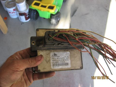 1994 Ford Bronco - Controller for anti-lock brakes, part number F47A-2C219-FA, with a bundle of colorful wires attached.